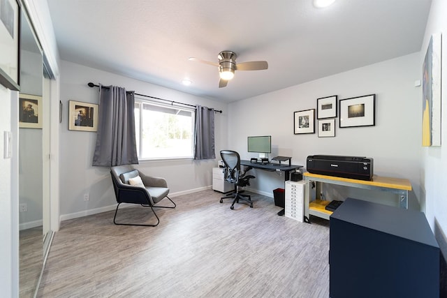 office area with a ceiling fan, baseboards, and wood finished floors