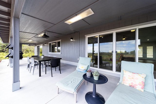 view of patio with french doors, outdoor dining space, and a ceiling fan