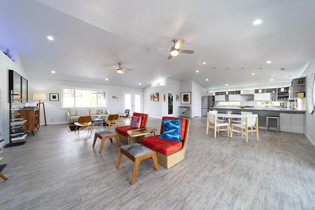 living area featuring baseboards, lofted ceiling, ceiling fan, wood finished floors, and recessed lighting