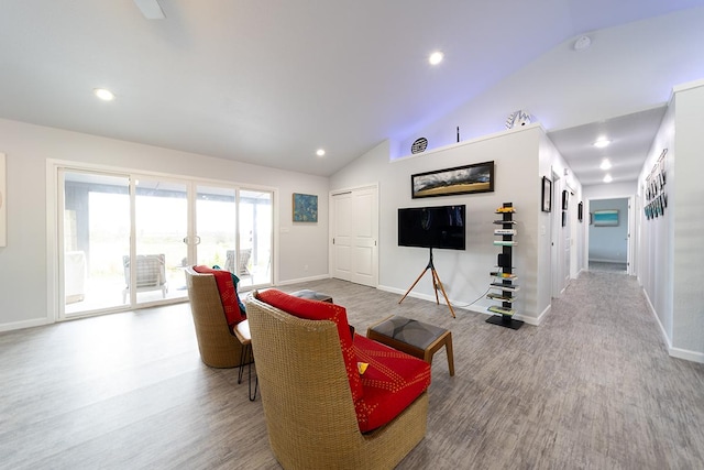 living area featuring baseboards, vaulted ceiling, wood finished floors, and recessed lighting