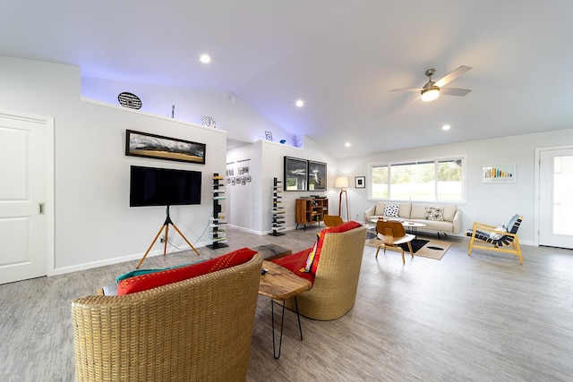 living room featuring baseboards, vaulted ceiling, and wood finished floors