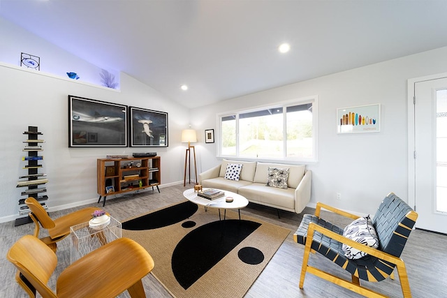 living area with lofted ceiling, baseboards, wood finished floors, and recessed lighting