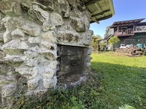 view of storm shelter featuring a lawn