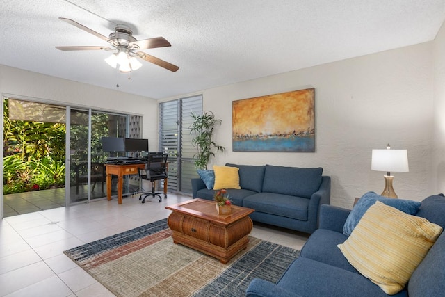 tiled living room with ceiling fan and a textured ceiling