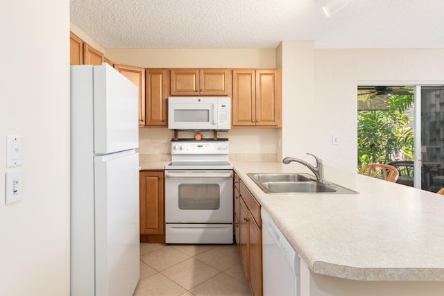 kitchen featuring sink, white appliances, light tile patterned floors, a textured ceiling, and kitchen peninsula