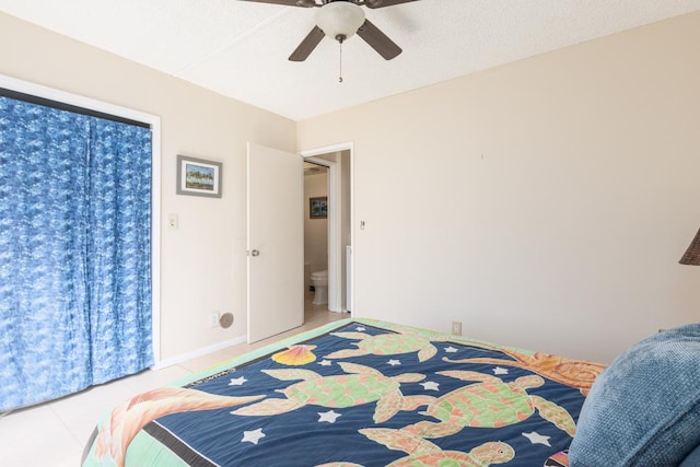 tiled bedroom featuring ceiling fan