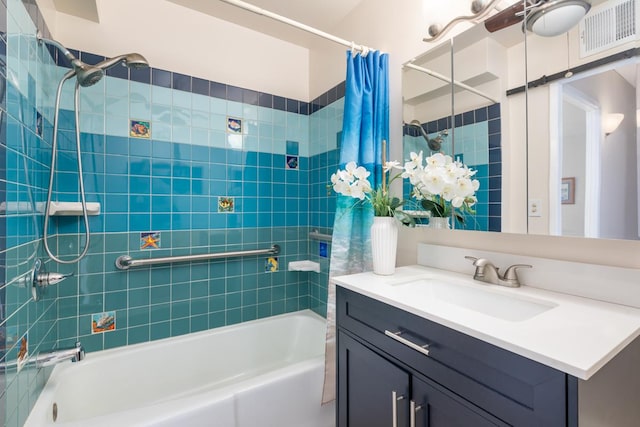 bathroom featuring shower / bath combo and vanity