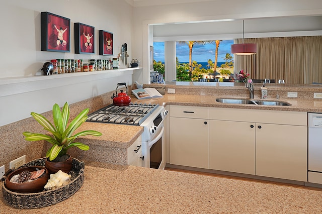 kitchen featuring sink, white cabinetry, white dishwasher, range with gas cooktop, and kitchen peninsula