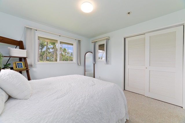 bedroom with a closet and light colored carpet