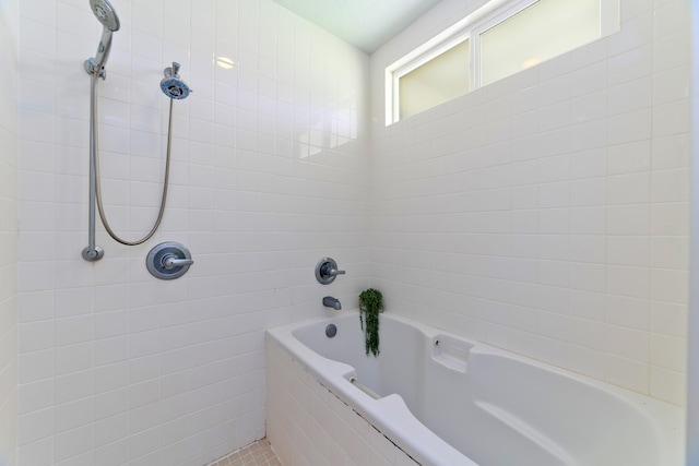 full bath with a tub and tiled shower