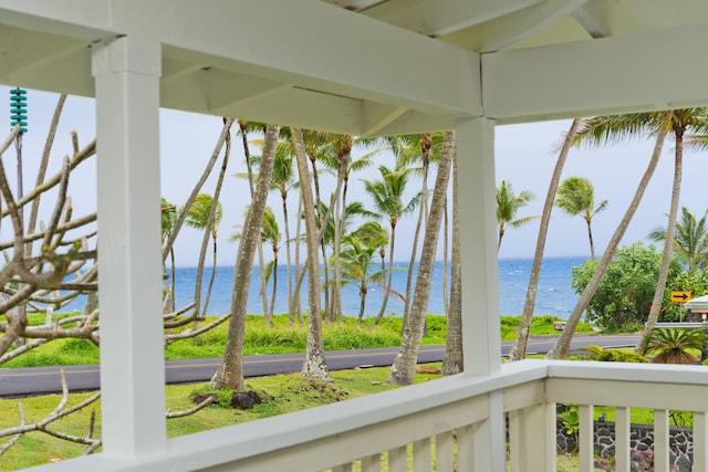 unfurnished sunroom featuring a water view