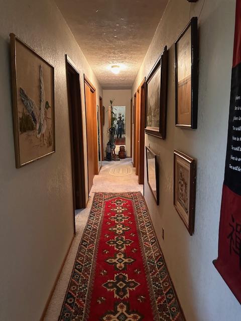 hallway with a textured ceiling