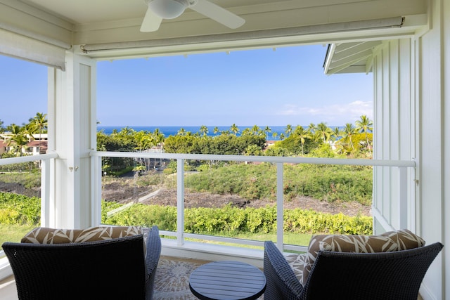 sunroom / solarium with a ceiling fan, a healthy amount of sunlight, and a water view