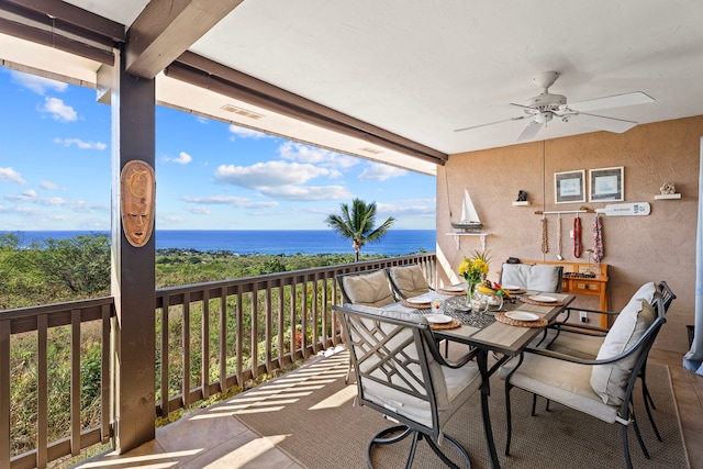 balcony featuring ceiling fan and a water view