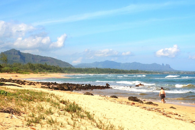 view of water feature with a mountain view and a beach view