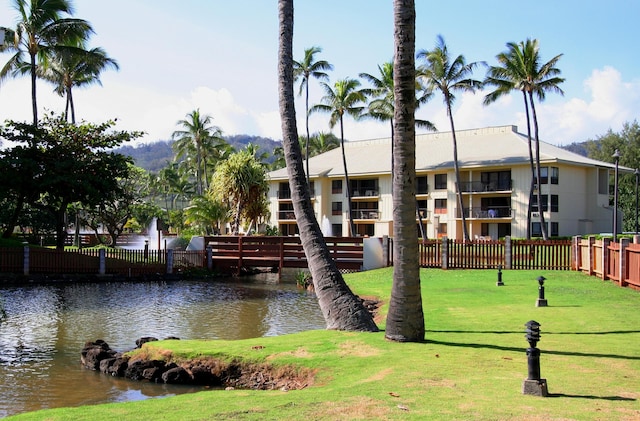 view of community with a water view and a lawn