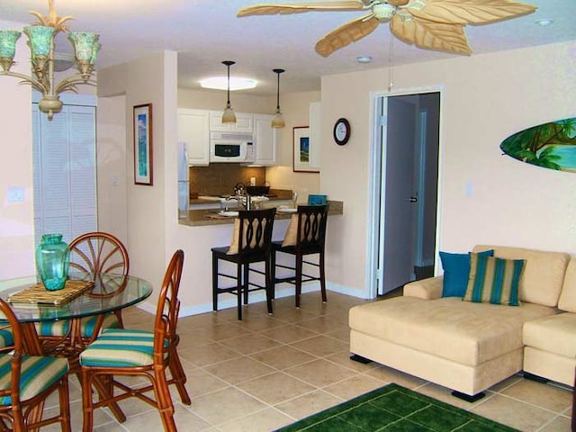 living room featuring ceiling fan and light tile patterned floors