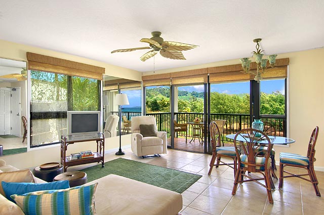 sunroom / solarium with ceiling fan with notable chandelier and plenty of natural light