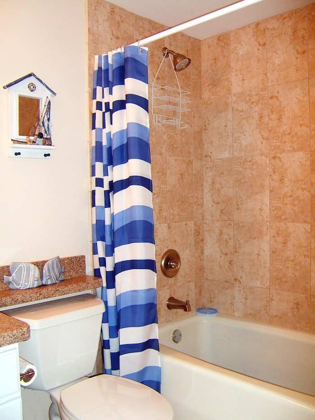 full bathroom featuring vanity, shower / bath combination with curtain, and toilet