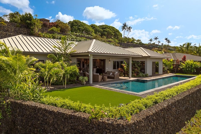 rear view of property with outdoor lounge area and a patio area