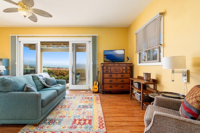 living room featuring a ceiling fan and light wood finished floors