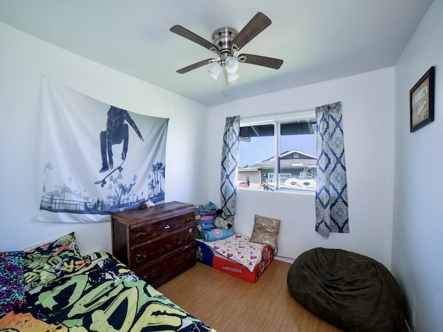 bedroom with a ceiling fan and wood finished floors