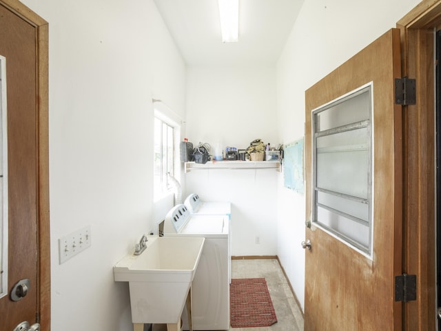 laundry room with laundry area, a sink, and washer and dryer