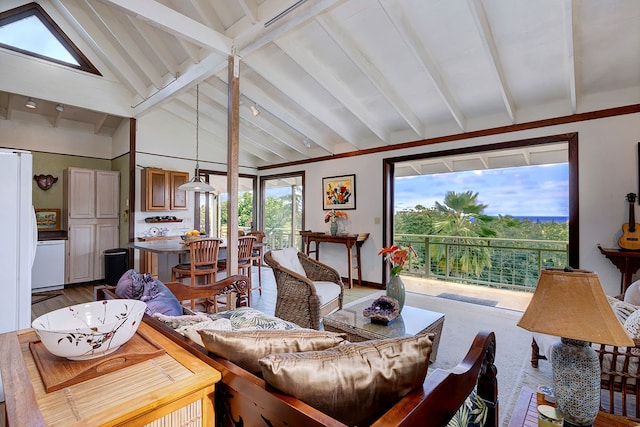 living room featuring hardwood / wood-style flooring, a healthy amount of sunlight, and vaulted ceiling with beams