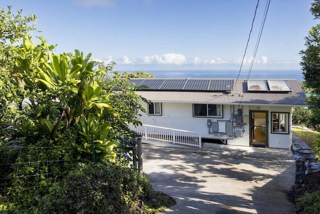 view of front of property featuring solar panels