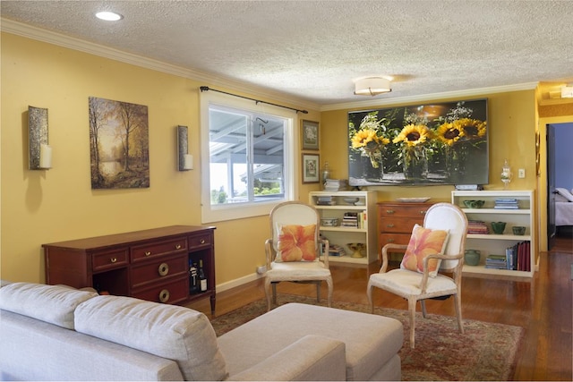 living area featuring wood-type flooring, a textured ceiling, and crown molding