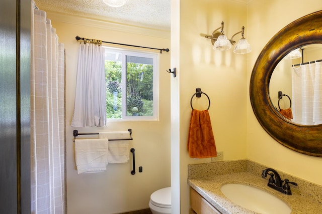 bathroom featuring vanity, toilet, and a textured ceiling