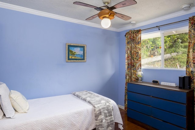 bedroom featuring crown molding, ceiling fan, dark wood-type flooring, and a textured ceiling