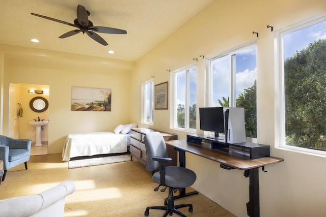 bedroom with sink, multiple windows, and light hardwood / wood-style flooring