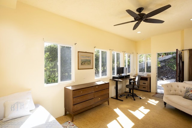 interior space with multiple windows, lofted ceiling, and ceiling fan