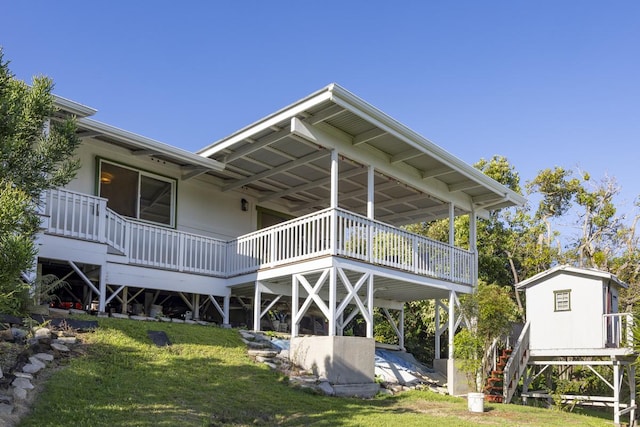 rear view of property featuring a lawn