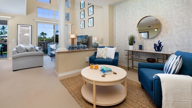 carpeted living room featuring a high ceiling