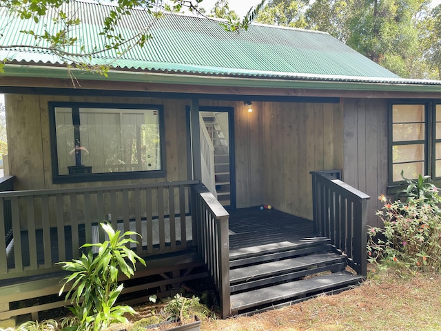 doorway to property with covered porch and metal roof