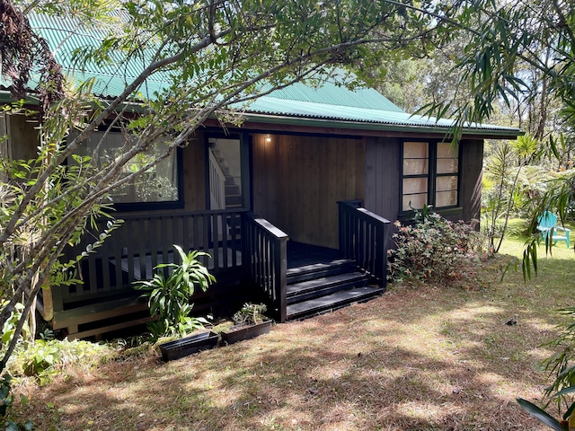 view of outbuilding featuring a sunroom