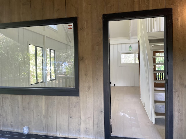 interior space featuring wooden walls and wood finished floors