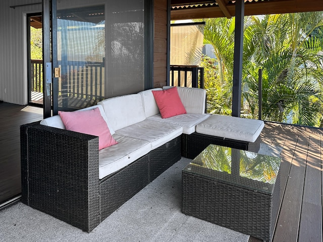 wooden terrace with an outdoor hangout area