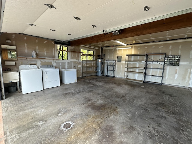 garage with secured water heater, washer and clothes dryer, and electric panel