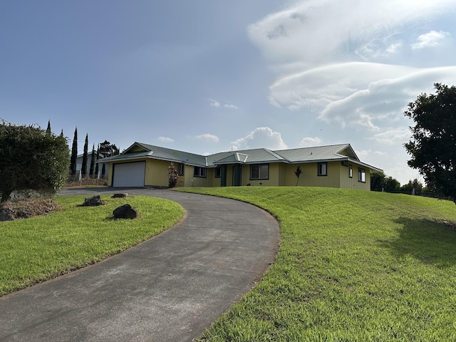 ranch-style home with a garage and a front yard