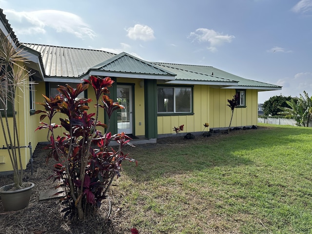 rear view of property with a lawn