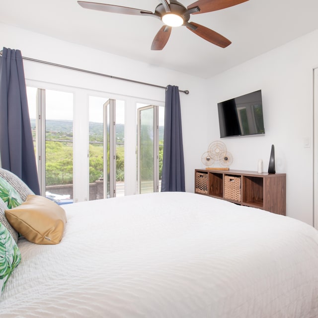 bedroom featuring ceiling fan and multiple windows