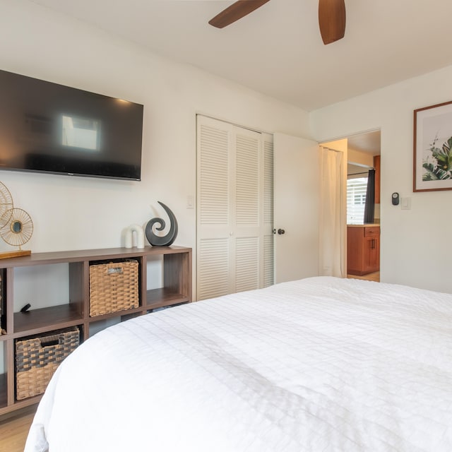 bedroom with ceiling fan and a closet