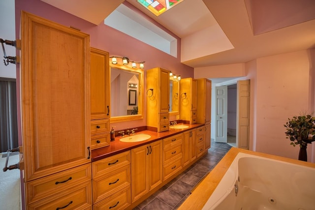 bathroom featuring a tub with jets and vanity