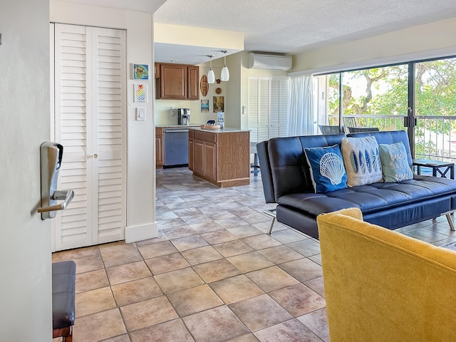 living area featuring a textured ceiling, a wall mounted AC, and light tile patterned flooring