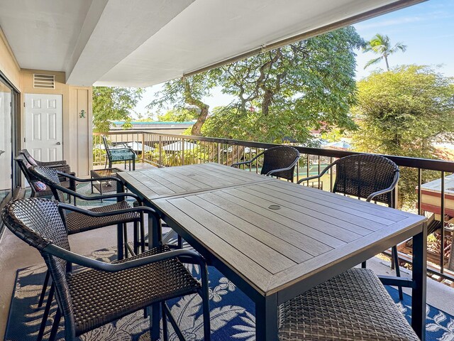 exterior space featuring outdoor dining area and visible vents