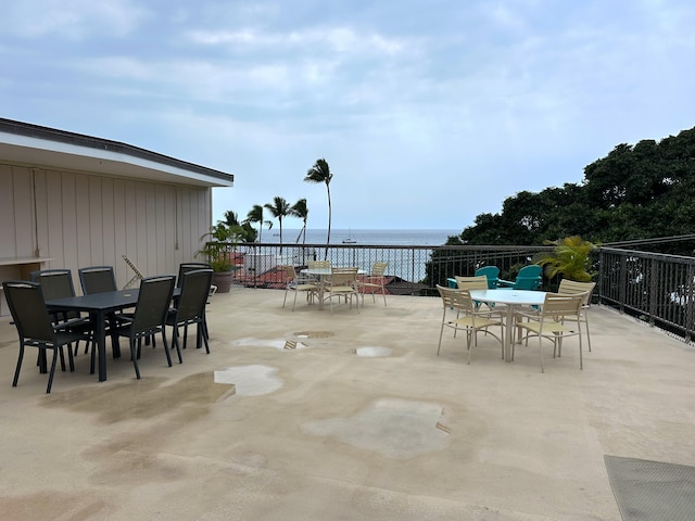 view of patio with outdoor dining area and a water view