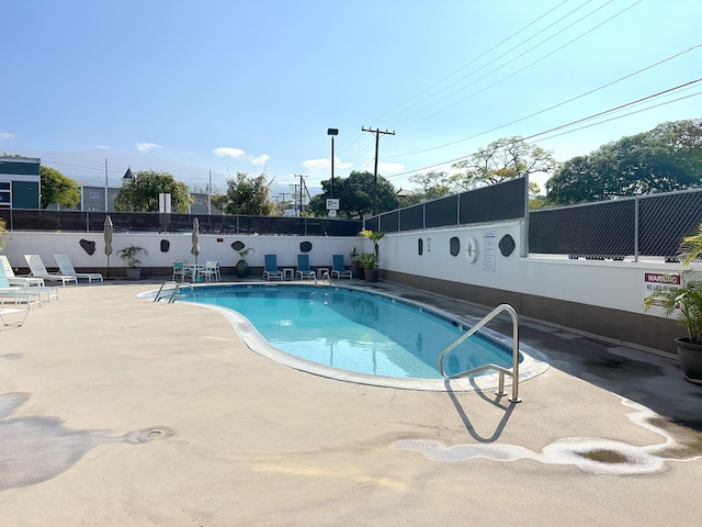 pool featuring a patio and fence